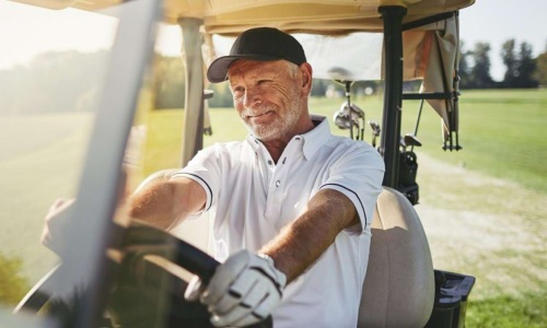 a man driving a golf cart