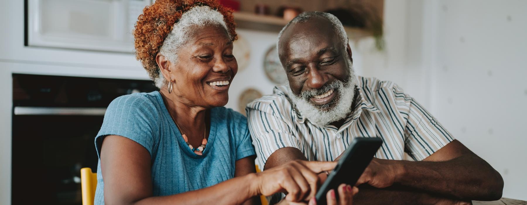 a man and a woman looking at a tablet