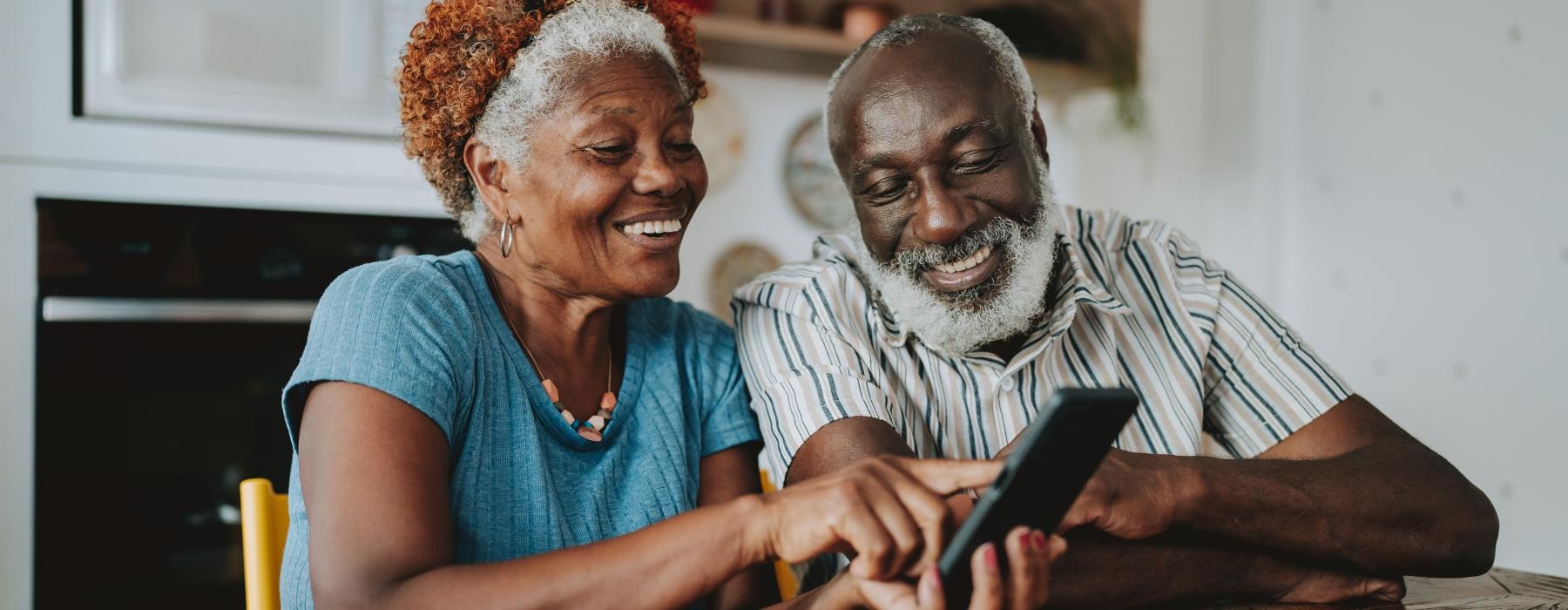 a man and a woman looking at a tablet