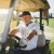 a man driving a golf cart